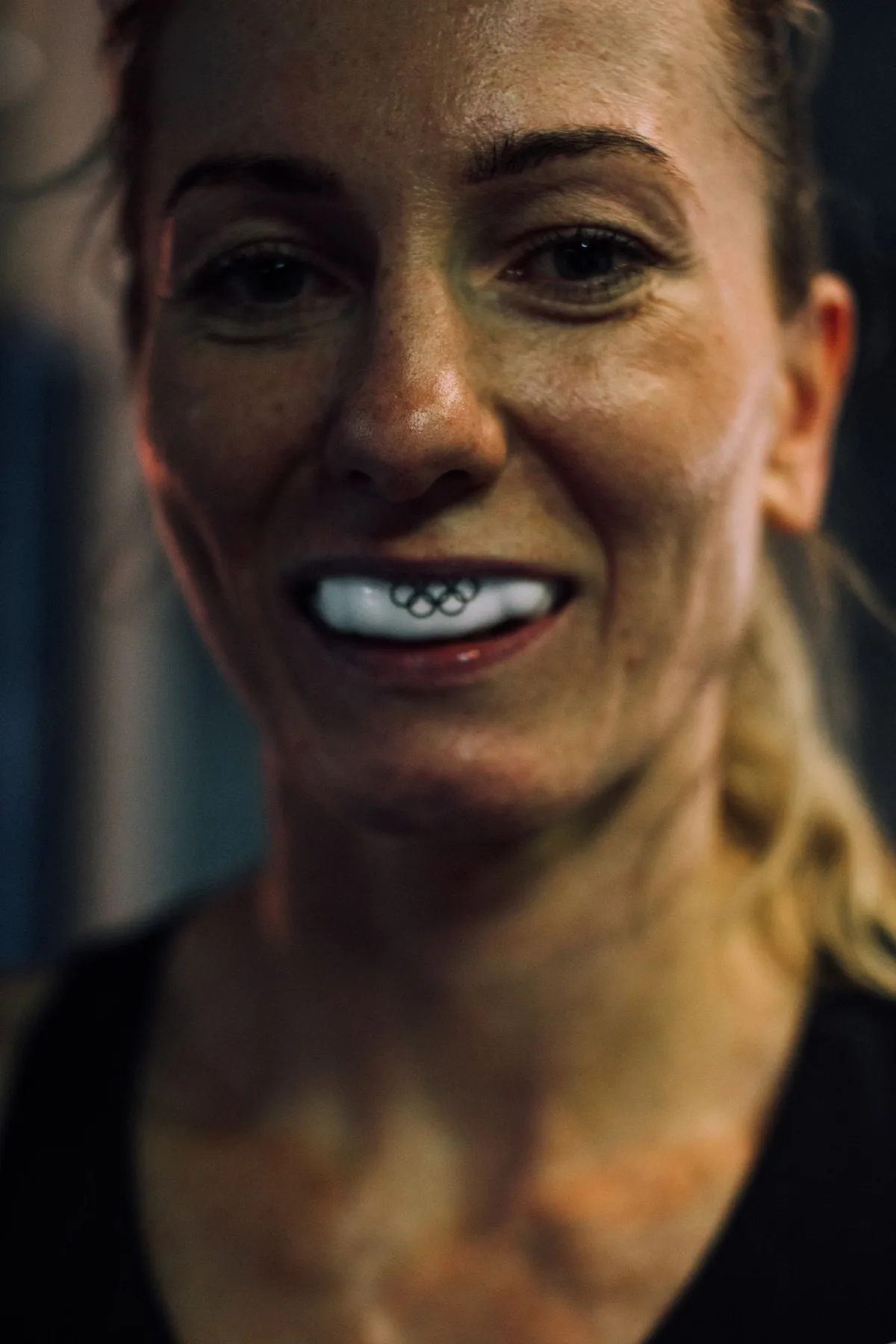 A woman wearing a protective sports mouthguard